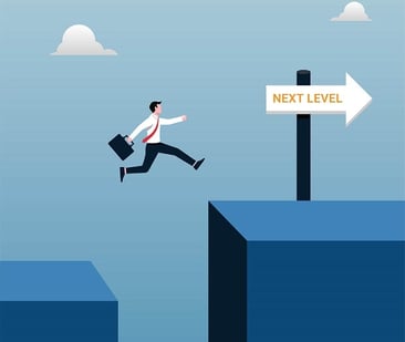 A businessman jumping from a lower platform to a higher platform next to a sign that reads Next Level