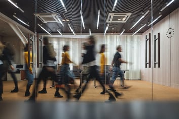 people-walking-through-an-office-quickly